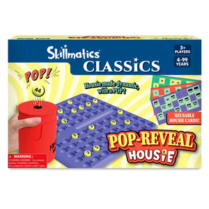 Front-facing view of the Skillmatics Classics Pop-Reveal Housie game box. The packaging shows a red pop-reveal can releasing a numbered ball, a blue number tray filled with yellow balls, and colorful reusable housie cards. Text highlights “Housie made dynamic, with a POP,” 3+ players, ages 4–99, and includes a small choking hazard warning.