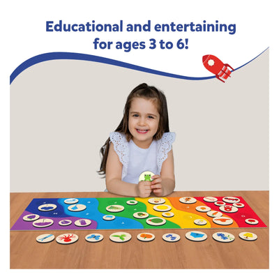 Young girl smiling while playing with Alphabet Rainbow magnetic matching game board