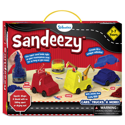 The Sandeezy box front shows jars of blue, yellow, and red kinetic sand, moulded vehicles including a red fire engine, a yellow crane truck, and a blue car base. Callouts highlight features like “Create 10+ unique vehicles,” “Sand holds tight,” and “Squish, Shape & Mould.” A “3–7 Years” badge is placed on top. The Skillmatics logo, warning label, road graphic, and included accessories like signs and wheels appear across the packaging.