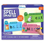 Front view of Skillmatics “Spell Smarter” spelling kit box for ages 4–7, featuring purple branding and sample write-and-wipe cards. Level 1 shows CVC word “cat” with kitten image, Level 2 shows word family “bell” with a ribboned bell, and Level 3 shows “block” with colored cubes. Text highlights 90 words, 45 reusable cards, 2 dry-erase markers, and choking hazard warning.