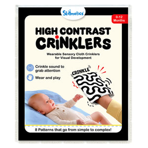 Skillmatics High Contrast Crinklers packaging for 0–12 months wearable sensory cloth toy. Shows baby on blue mat reaching toward hand holding black-and-white wavy crinkle cloth labeled CRINKLE. Includes logo, wear/play icons, crinkle sound note, and “8 patterns simple to complex” banner.