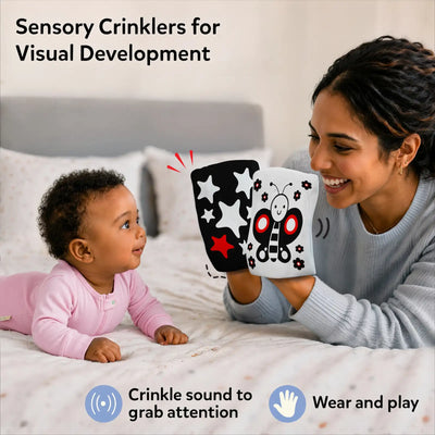 Lifestyle image for Skillmatics Sensory Crinklers. A mother smiles holding two cloth crinklers in front of a baby on a bed in pink outfit. Baby looks at star, butterfly and bee patterns. Text reads “Sensory Crinklers for Visual Development” with crinkle sound and wear and play icons.
