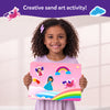 Young girl holding pink fairy tale-themed sand art board from Sand-Tastic Art Unicorns & Princesses