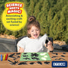 Young girl creating sun paper art with black silhouettes on glowing green mat in nature
