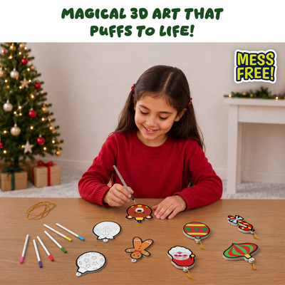 Lifestyle image showing a child creating Skillmatics Aqua Puffs Christmas ornaments at a table. The child colours 3D ornament pieces using markers while finished designs, including Santa, candy cane, bear, and bauble shapes, are displayed nearby. Scene includes Christmas tree background and highlights mess-free creative play.