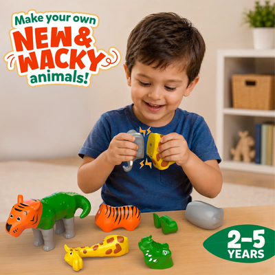 Young child sitting at a table indoors assembling Snap N Swap magnetic animal pieces, smiling while connecting giraffe, tiger, elephant and crocodile parts. Text reads ‘Make your own NEW & WACKY animals’, highlighting hands-on STEM play for ages 2–5 with colourful modular toy parts.