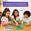 Three children sit around a wooden table actively playing the “Who Saw What?” card game. Each child holds green letter cards while reaching toward the center pile. Speech bubbles show shouted answers like “Donut,” “Rose,” and “Panda,” illustrating fast-paced gameplay. A yellow sand timer sits on the table, emphasizing time pressure. Text above reads “A lightning-fast card game where your memory panics under pressure!” and below reads “60 seconds to take it all in!”