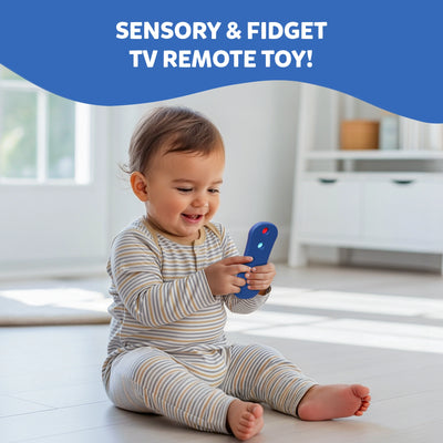 Baby sitting on a floor in a bright room smiling and playing with the Skillmatics Push & Pop TV Remote toy. The baby holds the colourful silicone remote while exploring the pop buttons. Text above reads "Sensory & Fidget TV Remote Toy!" highlighting this fun learning toy that builds sensory awareness, focus, and motor coordination in infants and toddlers.