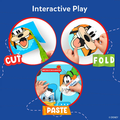 A blue background graphic titled “Interactive Play” showing three circular steps. The first shows a hand using green scissors to cut around a Disney character face. The second shows hands folding a cut paper shape. The third shows a child applying glue with a Skillmatics glue stick to paste pieces together. Labels reading “Cut,” “Fold,” and “Paste” guide the activity flow visually.