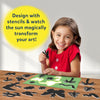 Young girl holding butterfly stencil with sun-activated art kit and colorful stencils