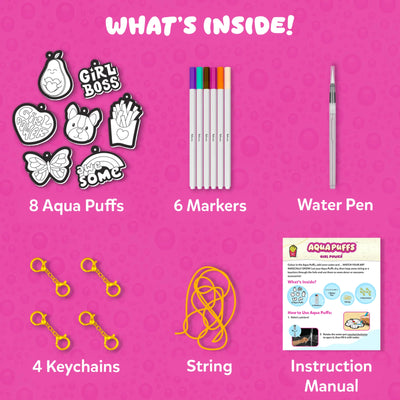 Flat lay on pink bubble background titled “What’s Inside!” showing kit contents: 8 black and white Aqua Puff cutouts including pear, Girl Boss text, fries, butterfly, dog face, rainbow and heart designs; 6 colored markers; 1 water pen; 4 gold keychain clips; yellow string; and printed instruction manual explaining steps and included items.
