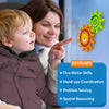 A smiling mother holds a toddler while both look toward two Skillmatics Spinny Gears on a window — an orange lion gear interlocked with a green caterpillar gear. A blue box lists skills developed: Fine Motor Skills, Hand-eye Coordination, Problem Solving, and Spatial Reasoning. 