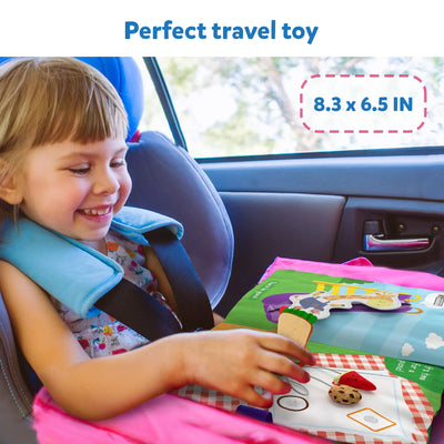 Happy young child playing with My Quiet Book Sensory Activity Book in car seat