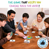 Family of five gathered around a wooden table playing Skillmatics Cross Over card game. Children and parents hold colorful picture and category cards while rapidly placing matches in the center. Headline reads “The Game That Keeps You Coming Back for More,” with a family-friendly game night favorite badge.