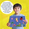 Young boy proudly displaying colorful cyanotype art with Sun Paper Art Kit in nature