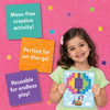Smiling girl in a blue shirt holds a completed Skillmatics Felt Fun hot air balloon picture board with colorful felt squares on a pink felt background. Three overlapping felt squares display text: Mess-free creative activity, Perfect for on-the-go, and Reusable for endless play.