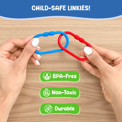 Close-up of adult hands holding two interlocked plastic links in blue and red over a wooden surface, demonstrating connection strength. Text reads “Child-safe Linkies,” with icons and labels below indicating BPA-free, non-toxic materials, and durable construction. The image focuses on safety, material quality, and secure linking design without showing a child.