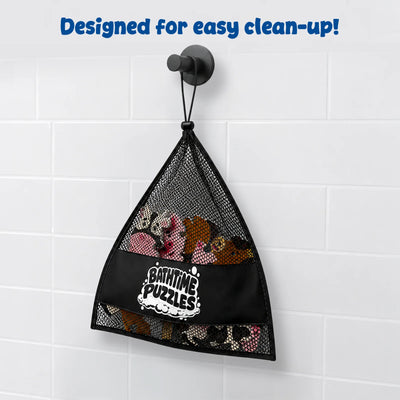 A black mesh storage bag labeled "Bathtime Puzzles" hangs from a bathroom wall hook against white tiles. The bag contains colorful foam farm animal puzzle pieces and demonstrates convenient storage, quick drying, and easy clean-up after bath play sessions for young children.