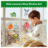 Young boy applying colorful animal-shaped window clings from Waxy Window Art for Kids