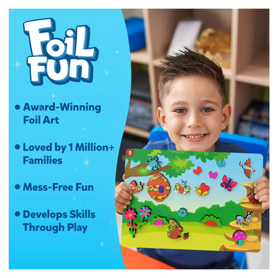 Young boy happily holding colorful foil art kit with bugs and butterflies for kids ages 4-9