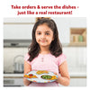 Young girl holding a toy plate with food cutouts from Little Chefs Creative Kit