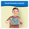 Young boy proudly holding colorful marbled artwork from Playful Colours & Patterns Bundle