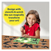 Young girl holding butterfly stencil with sun-activated art kit and colorful stencils