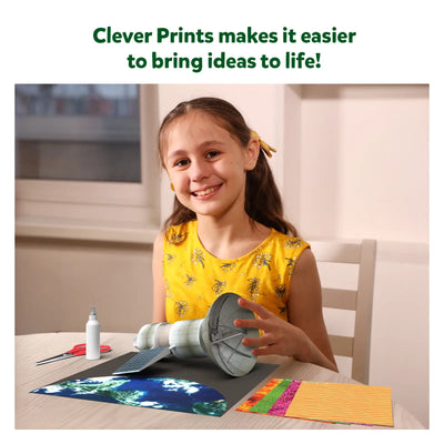 Young girl smiling while crafting a model satellite with Construction Paper from Clever Prints
