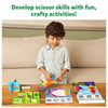Child using scissors in Snip Snip Amazing Animals craft activity kit for ages 3-7