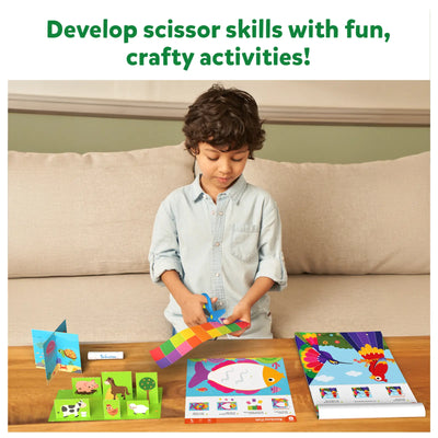 Child using scissors in Snip Snip Amazing Animals craft activity kit for ages 3-7