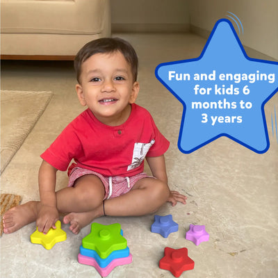 Smiling toddler playing with colorful star-shaped silicone stacking toys from Starry Stacker