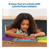 Young girl creating ocean-themed art with colorful foam stickers from Fun with Foam Under the Ocean