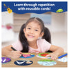 Smiling young girl using colorful reusable learning cards and a marker for toddlers