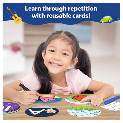 Smiling young girl using colorful reusable learning cards and a marker for toddlers